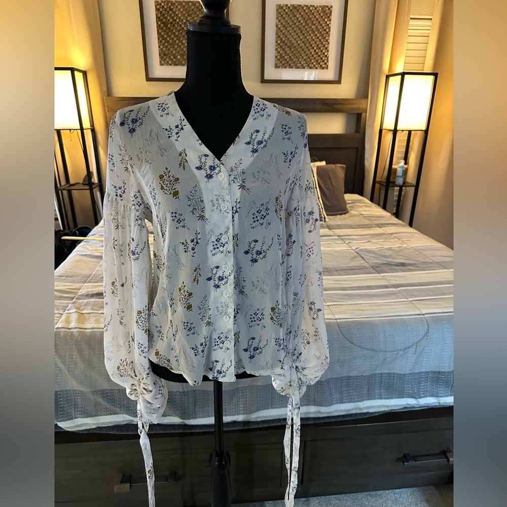 Floral V- neck blouse with bell sleeves.